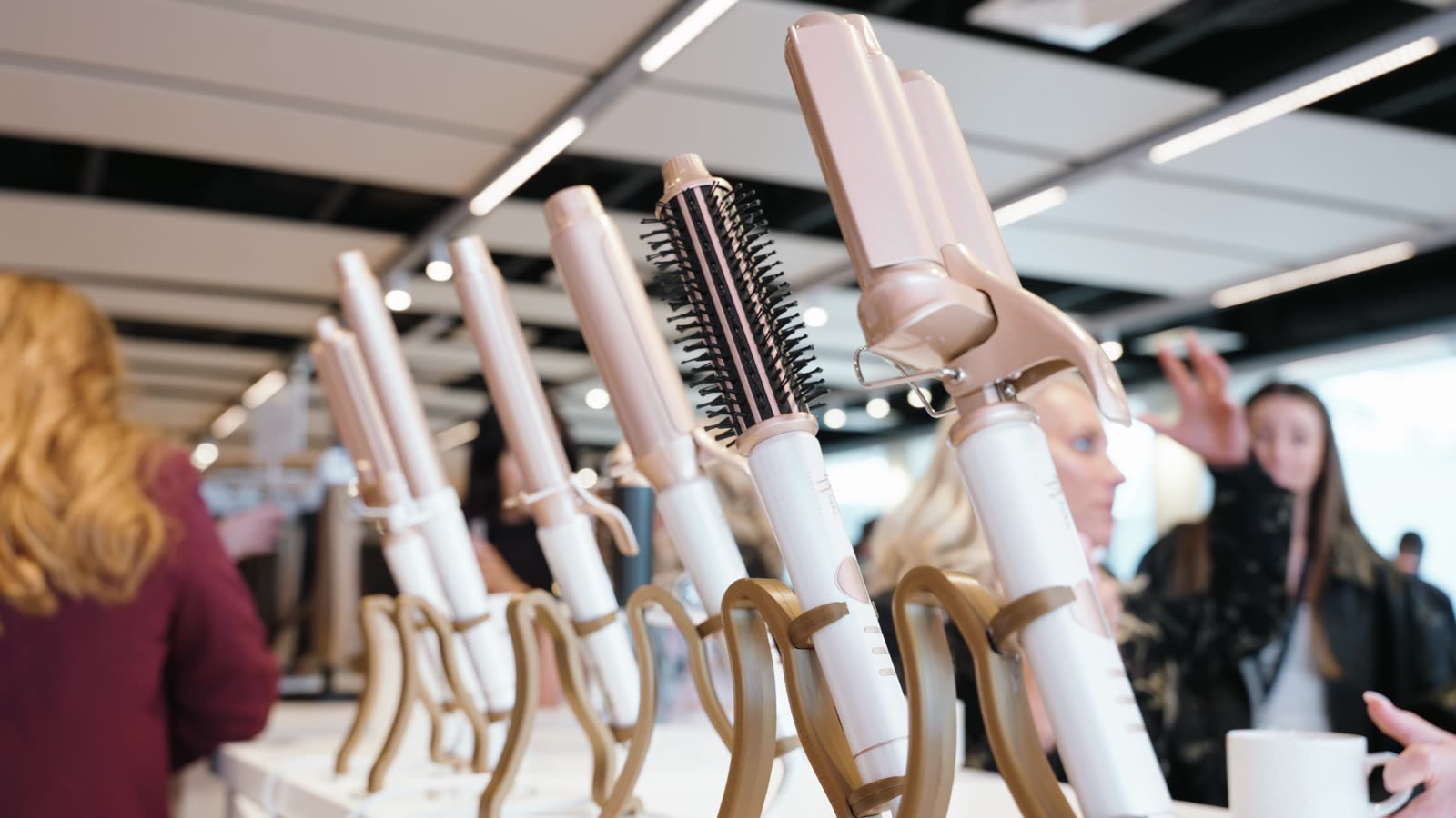Beauty Works styling tools on display with guests behind them