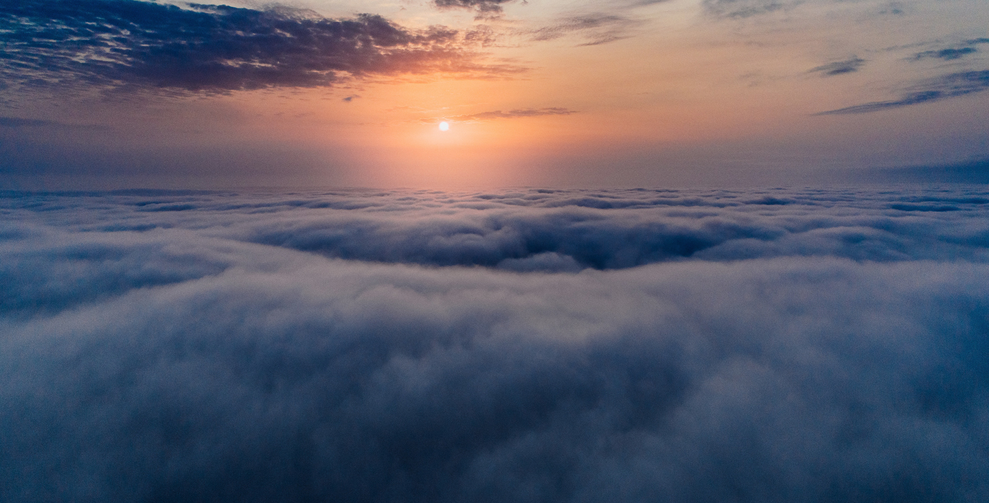 Aerial view above a layer of cloud at sunrise